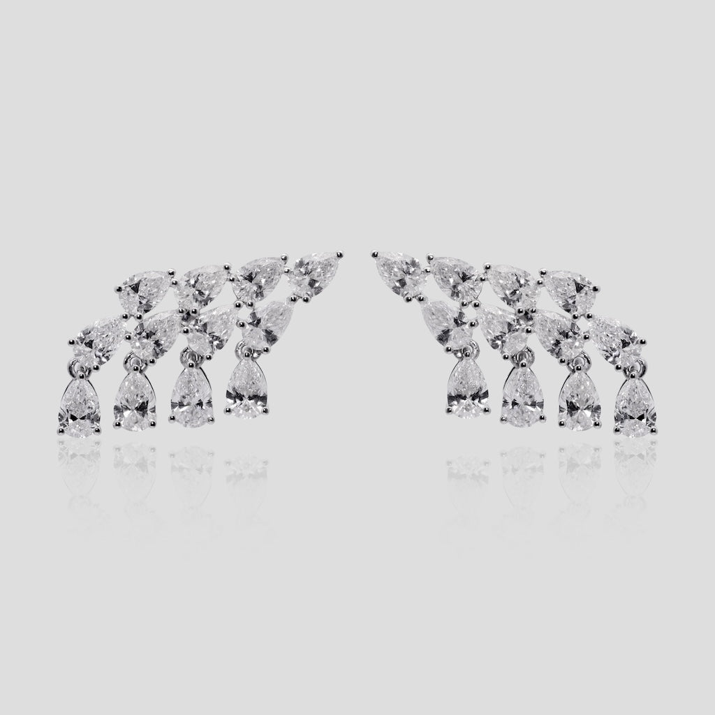 Pair of diamond earrings on a light gray background