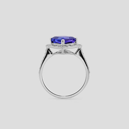 White Gold ring with a blue tanzanite gemstone kite shaped on a light gray background