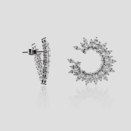 Pair of white gold earrings with real diamonds on a light gray background