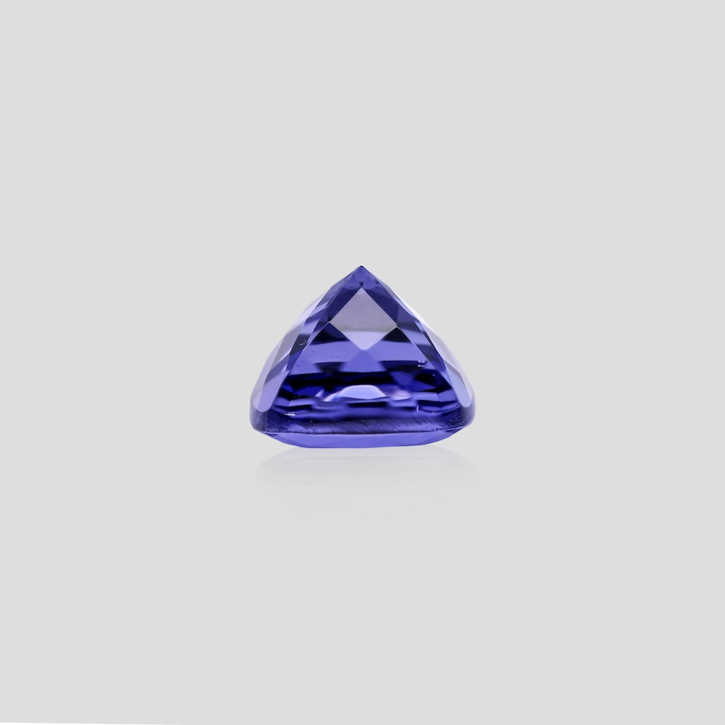 cushion-shaped purple gemstone on a light gray background