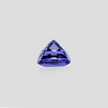 cushion-shaped purple gemstone on a light gray background