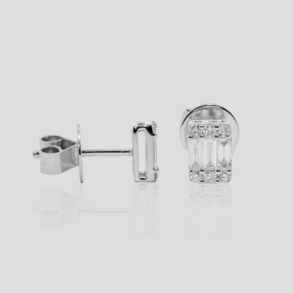 Pair of baguette diamond earrings in white gold on a light gray background