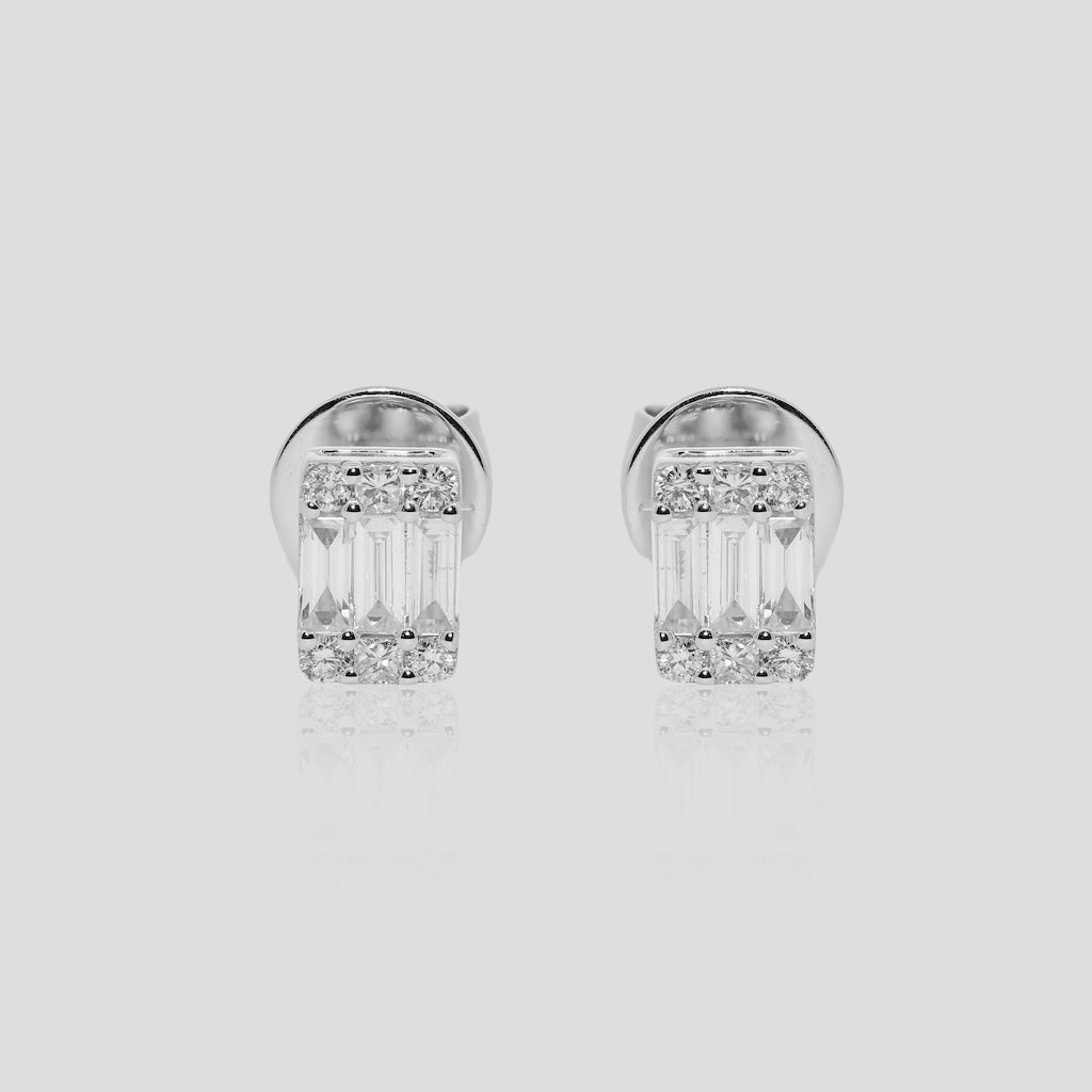 Pair of baguette diamond stud earrings on a light gray background