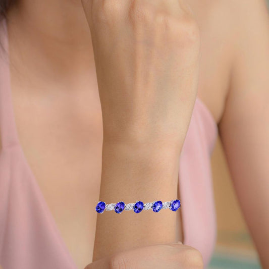 Oval tanzanite bracelet with diamond accents on a woman's wrist