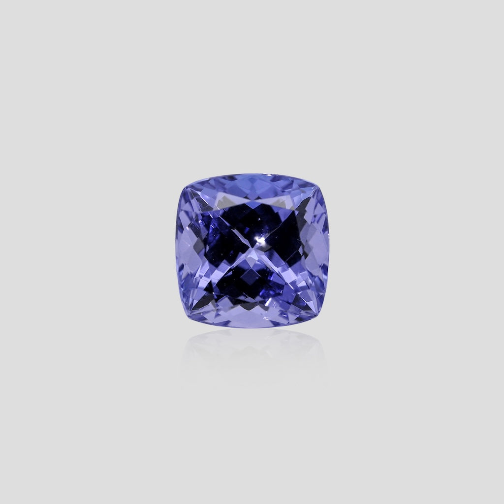 tanzanite blue gemstone on a light gray background