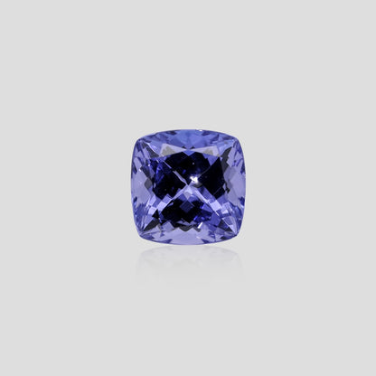 tanzanite blue gemstone on a light gray background
