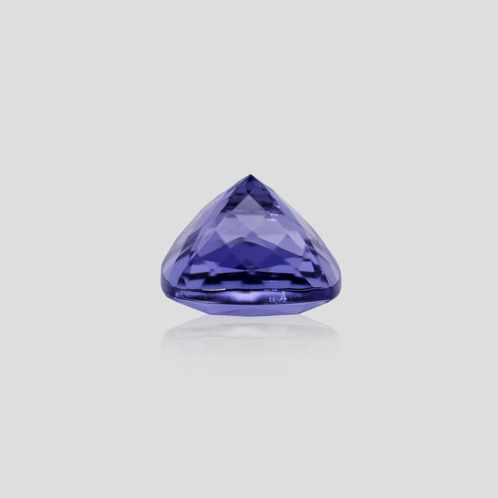 cushion-shaped purple gemstone on a light gray background