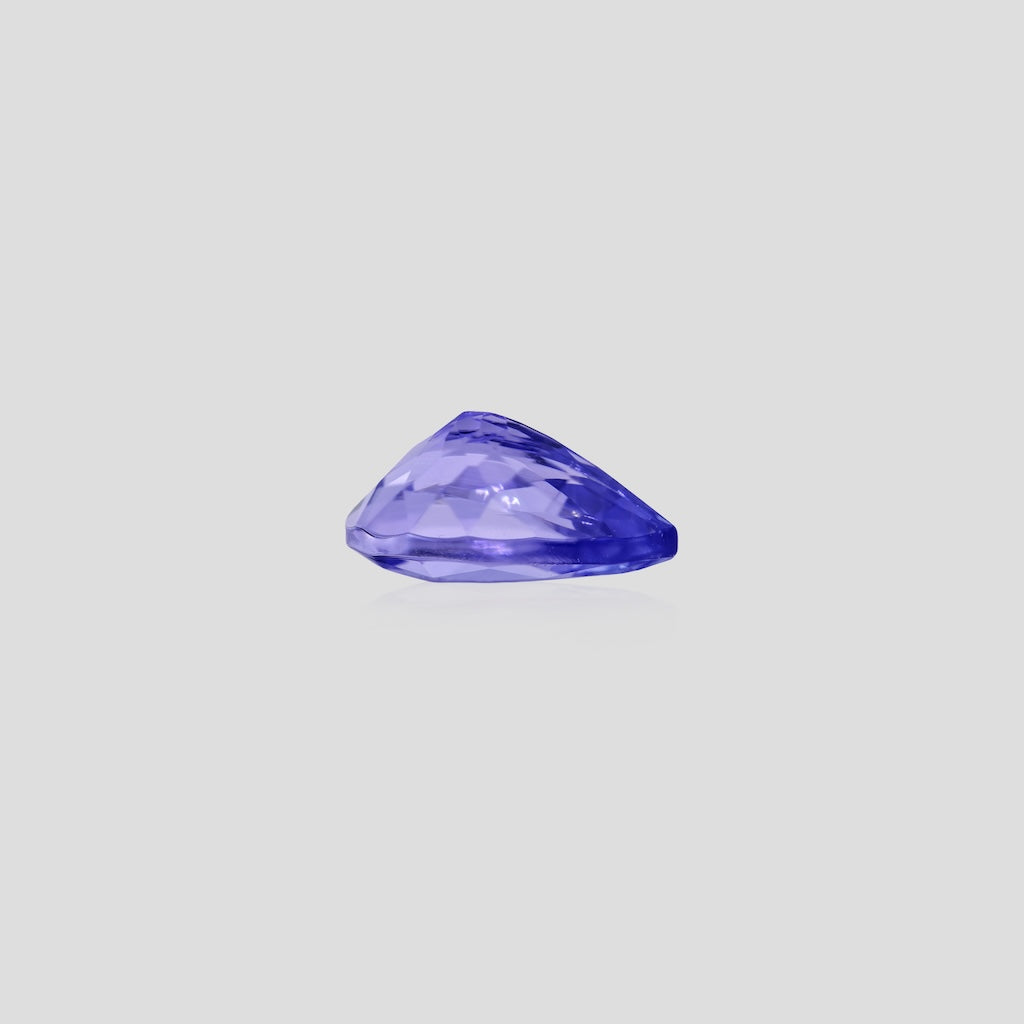 Faceted pear tanzanite 9x7mm on a light gray background