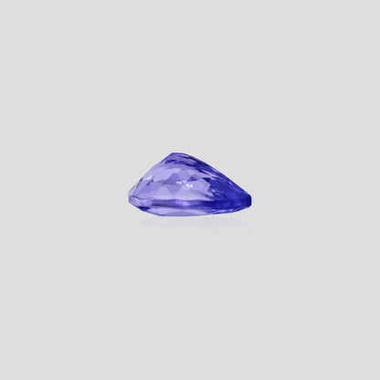 Faceted pear tanzanite 9x7mm on a light gray background