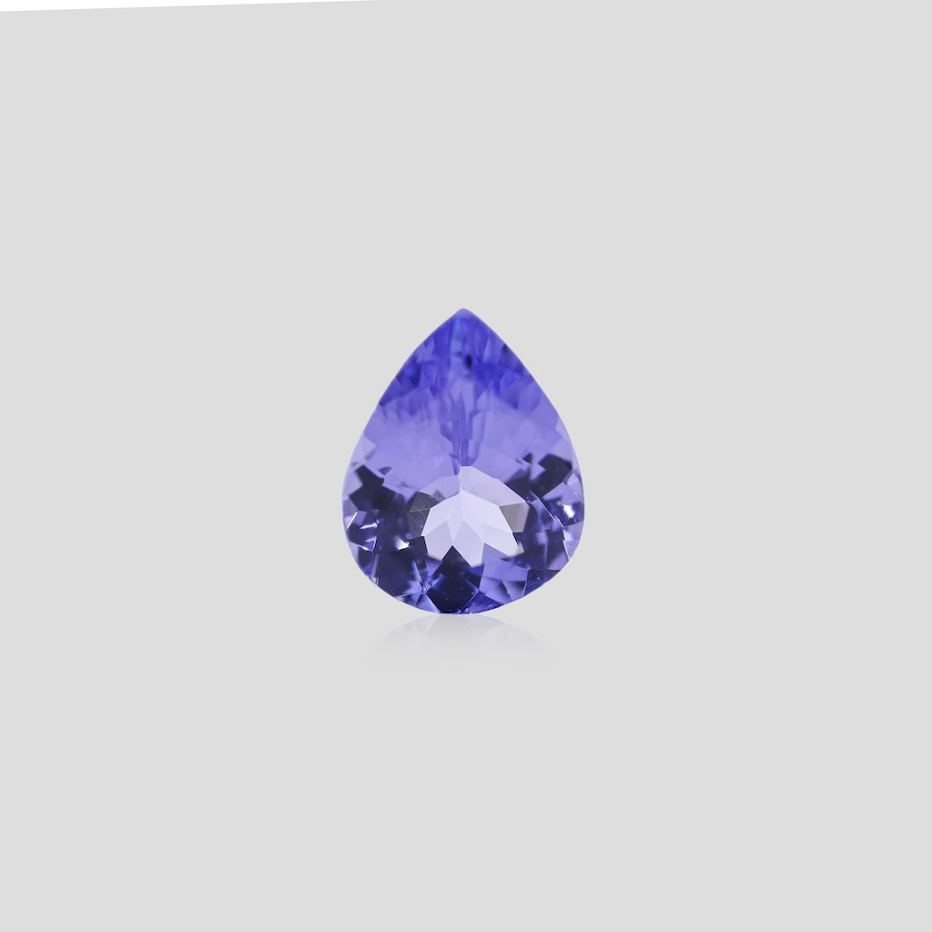 Faceted pear tanzanite 9x7mm on a light gray background