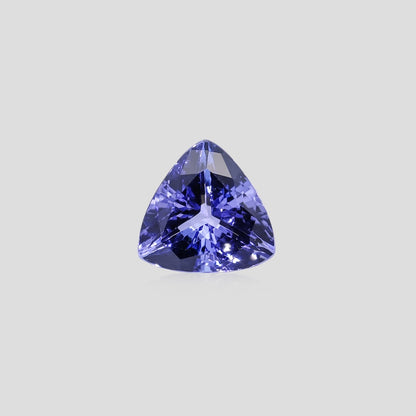 Trillion-shaped purple gemstone on a light gray background