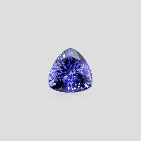 Trillion-shaped purple gemstone on a light gray background