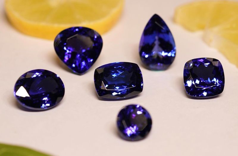 tanzanite blue gemstones on a light background